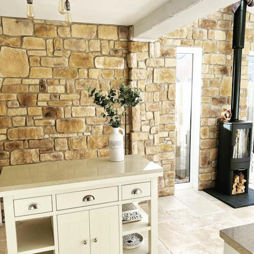 What are the key benefits of using natural stone cladding on modern building facades?